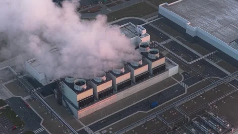 Cloud data center cooling system releasing steam at sunset Stock Footage 334056559