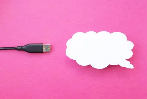 Cloud for data storage cut from paper on a pink background and cable usb, close 写真素材