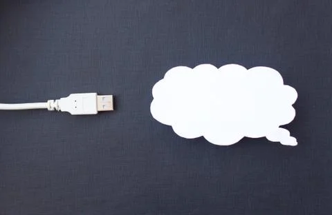 Cloud for data storage cut from paper on a black background and cable usb, close Stock Photos