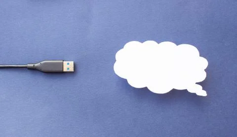 Cloud for data storage cut from paper on a blue background and cable usb, close Stock Photos