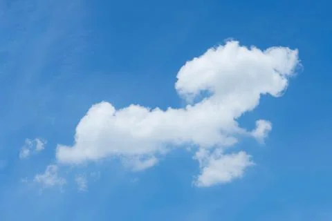 Cloud like a dog, a dachshund, is running in the bright sky. Stock Photos