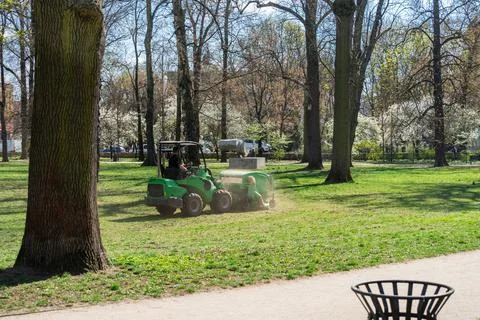 Cloud Dust and Small Slice Around Machine for Cleaning Lawns in Krakow Park Stock Photos