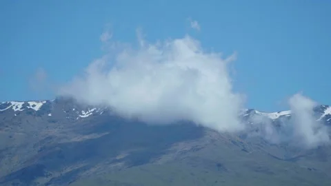 Cloud floating close to mountain range 스톡 동영상 260850262