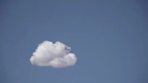 Cloud floating in a vast blue sky Stock Footage 240933399