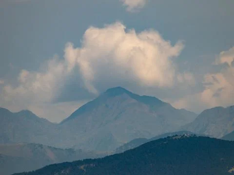 Cloud Formation Behind Mountain Peak Stock Photos