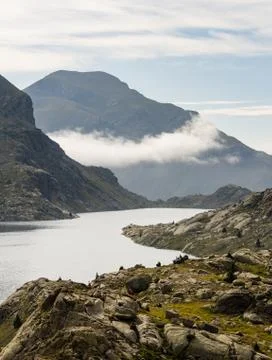 Cloud Formation Between Lake and Mountain Hillside Stock Photos