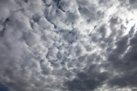 Cloud formations in the blue summer sky Stock Photos
