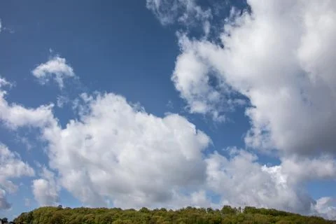 Cloud formations in the blue summer sky Stock Photos