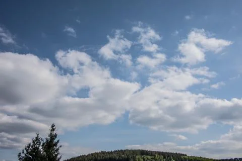 Cloud formations in the blue summer sky Stock Photos