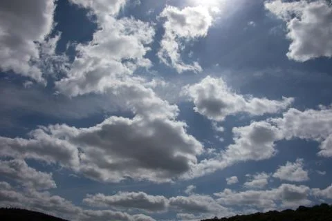 Cloud formations in the blue summer sky Stock Photos