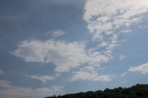 Cloud formations in the blue summer sky Stock Photos