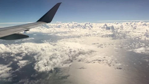 Cloud formations in skies with the tip of an airplane wing  Stock Footage 122683468
