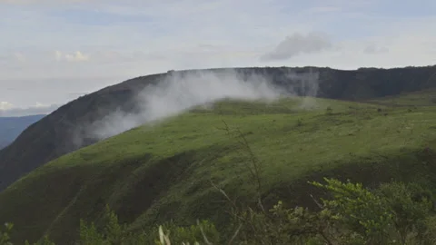 Cloud forming on top of a mountain Stock Footage 138397526