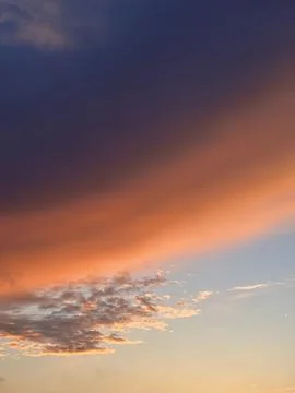 Cloud of gradient color from orange to dark blue during sunset Stock Photos