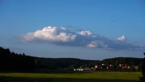 A cloud growing over a rural settlement Stock Footage 113595264
