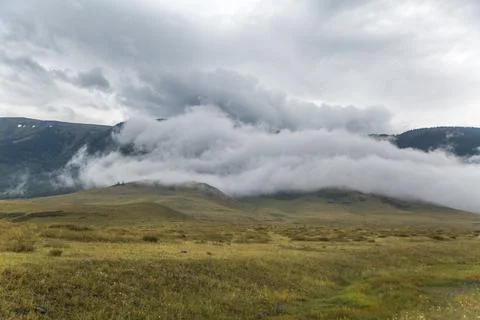 A cloud on a hill in the highlands Stock Photos