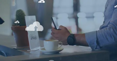 Cloud icons against mid section of a caucasian man scanning qr code with his Stock Photos
