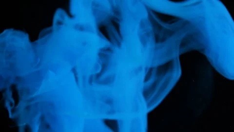 Cloud of ink floating slowly trough space, close up, black background Stock Footage 75599656