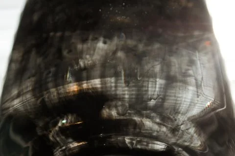 A cloud of ink in a transparent glass cup with clear water against the backdr Stock Photos