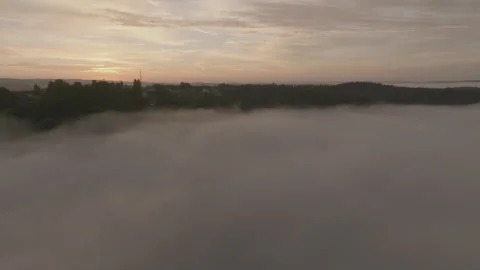 Cloud inversion clouds reveal rolling green hills landscape at sunrise  Stock Footage 301316656