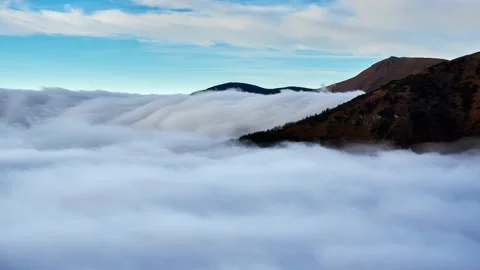 Cloud inversion, clouds spill over the mountain, waterfall from the clouds 動画素材 167894050