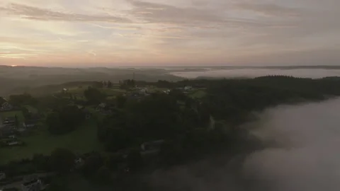 Cloud inversion over rolling green hills landscape at sunrise  Stock Footage 301316598