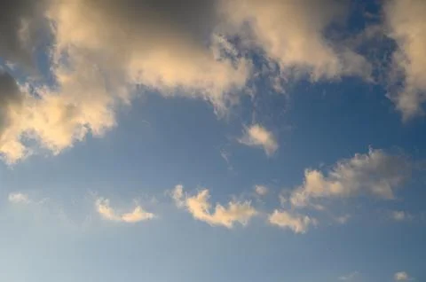 Cloud landscape clear blue sky with golden and white clouds illuminated by .. Фото