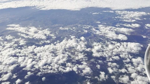 Cloud Layer Pattern Above Rugged Landscape Seen From Airplane Stock Footage 321860820