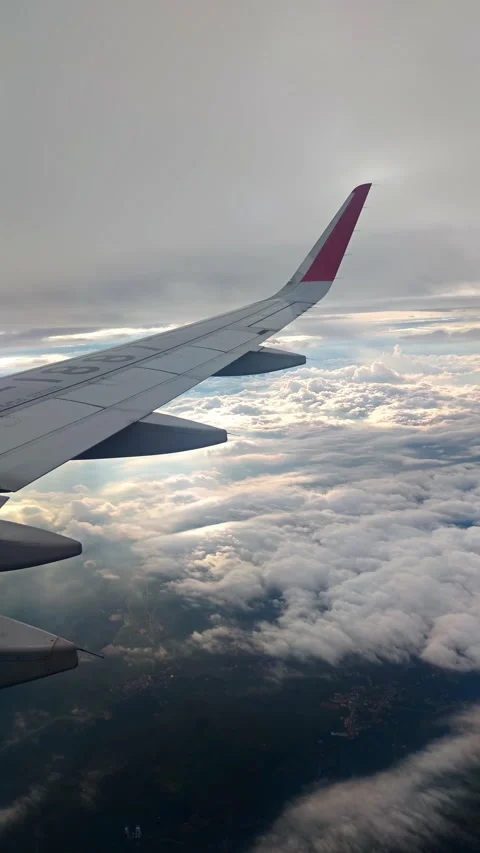 Cloud Layers and Crepuscular Rays From Airplane Window Stock Footage 320947131