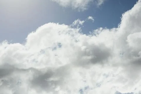 Cloud layers are drifting across flat design sky backdrop, showing soft shadows Stock Photos