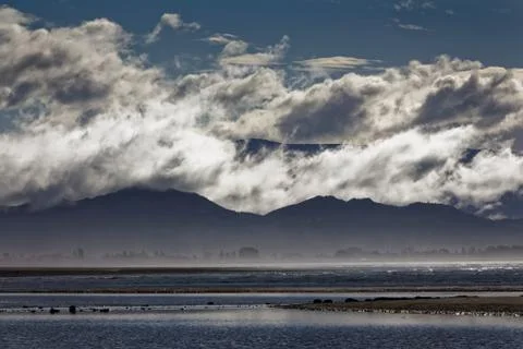 Cloud layers on hills Stock Photos