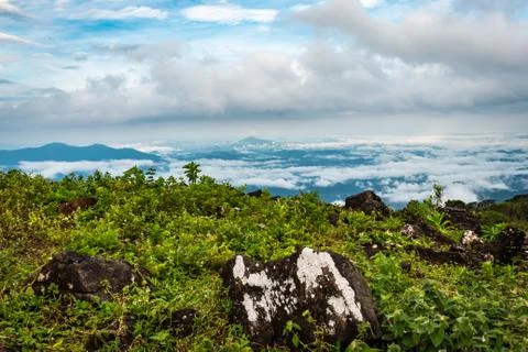 Cloud layers on mountain horizon with green grass 写真素材
