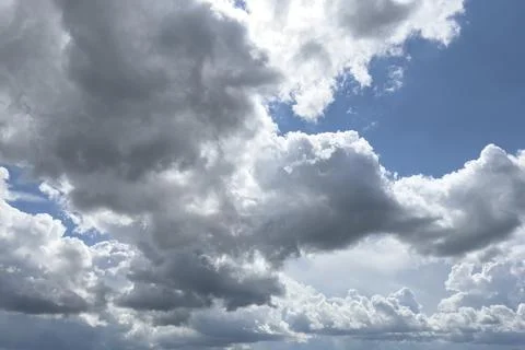 Cloud layers move across sky with sunlight breaking through. Dynamic weather 스톡 사진