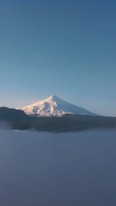 Cloud-level aerial shot showing the amazing Villarrica volcano in the Arauc.. Stock Footage 289688713