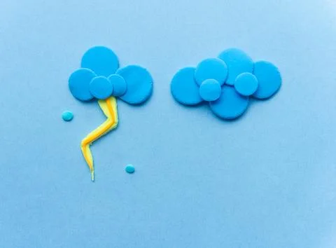 Cloud with lightning from plasticine on blue background Stock Illustration