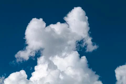 A cloud looking like a figure, model or person with lifted arms. Stock Photos