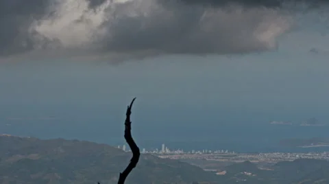 Cloud Motion above Hills City Sea Tree Trunk on Foreground Stock Footage 65206239