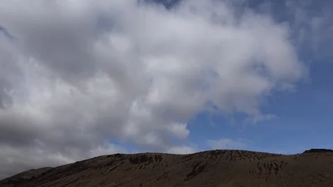 Cloud moves over barren hill time lapse Stock Footage 93055964