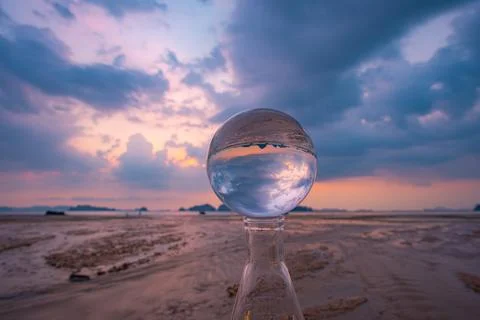 Cloud moving in beautiful sunset inside crystal ball. Stock Photos