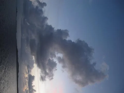 Cloud on the ocean at sunset Stock Photos