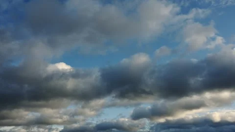 A cloud only time lapse of white, blue and gray clouds in a blue sky.  Stock Footage 256105265