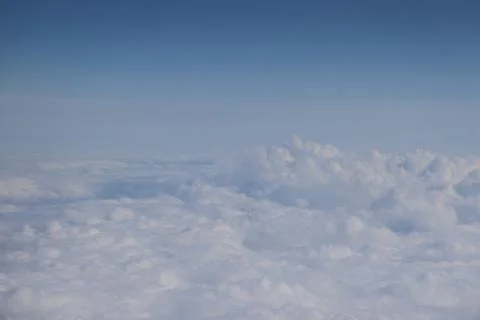 Cloud opening revealing mountain landscape below 스톡 사진