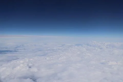 Cloud opening revealing mountain landscape below 스톡 사진