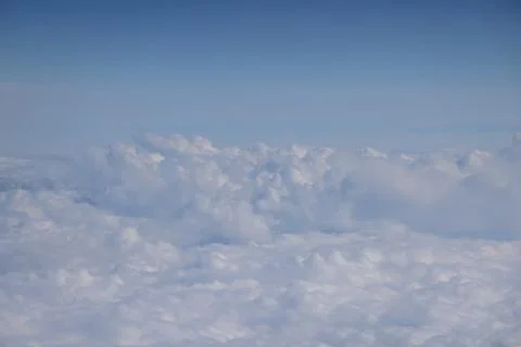 Cloud opening revealing mountain landscape below 스톡 사진