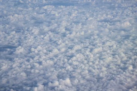 Cloud opening revealing mountain landscape below 스톡 사진