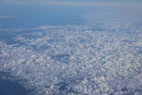 Cloud opening revealing mountain landscape below 스톡 사진