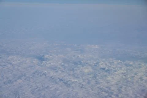 Cloud opening revealing mountain landscape below 스톡 사진