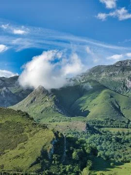 Cloud over green mountain range landscape - Majestic summer view of Picos d.. Stock Photos