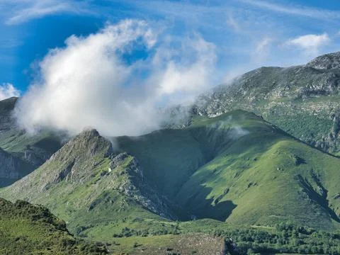 Cloud over green mountain range landscape - Majestic summer view of Picos d.. Stock Photos