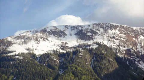 Cloud over snowy mountaintop video Stock Footage 38022392